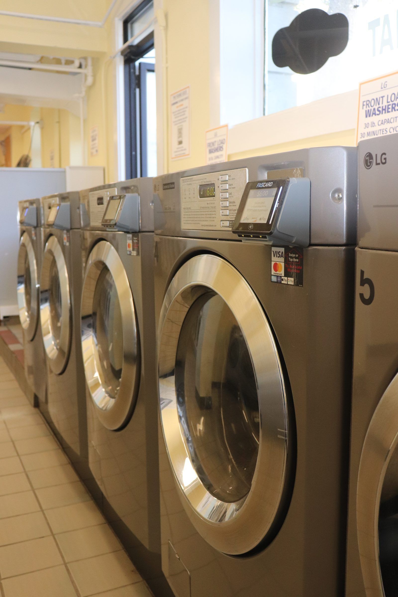 Row of LG large-capacity front-load washers, looking down the line